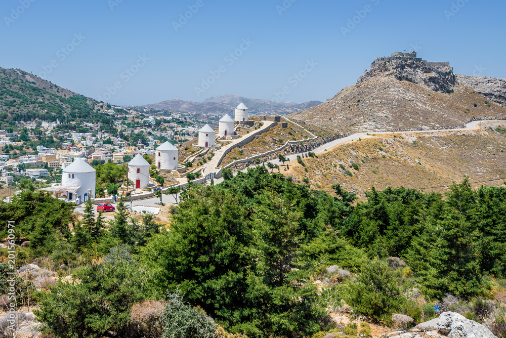 Greek Windmills of Panteli, Leros Island, Greece: Shining bright white on the mountain top of the small Dodecanese Islands on the road to ancient medieval castle Castro