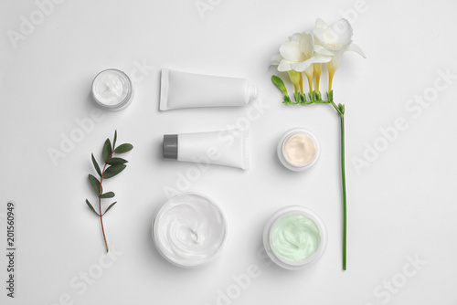 Flat lay composition with cosmetic products on light background