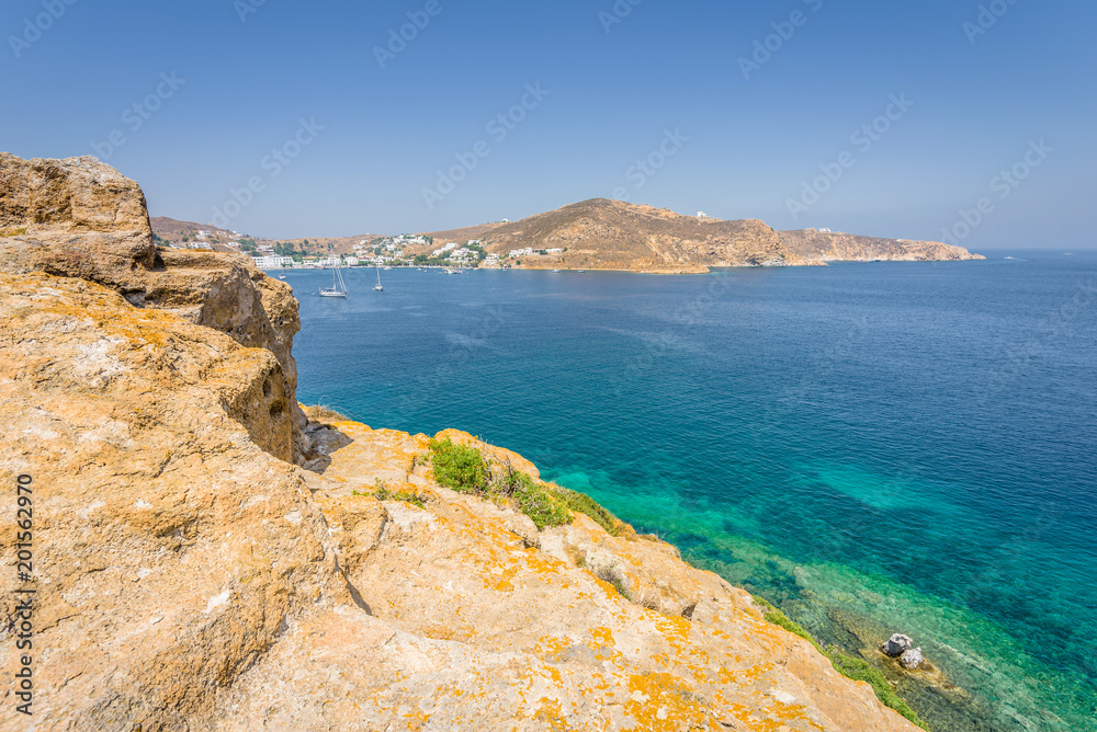 Beautiful sunny holiday coast view to a empty holiday bay with crystal clear blue water sandy greek beach for sunbathing and some boats cruising fishing, Patmos Island, Kos, Dodecanese/ Greece