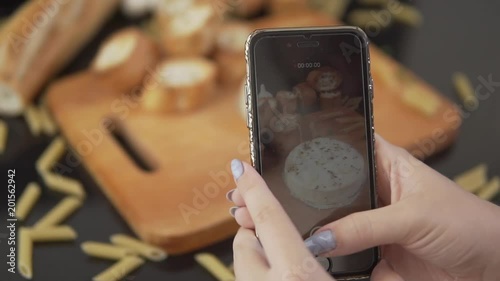 Woman takes off the cooking process Camembert. Slow motion closeup photo