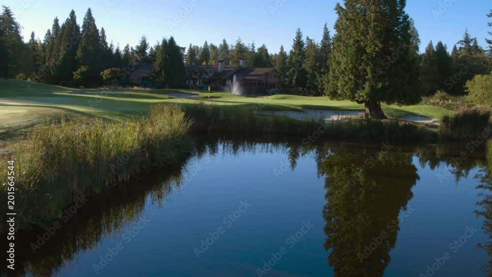 Water feature by lake and accommodation at golf resort. Water feature by lake and accommodation at golf resort.
