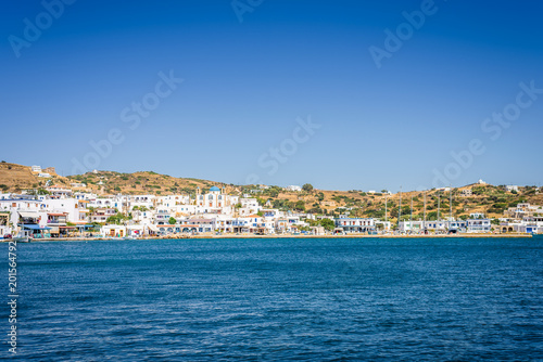 Lipsi, Patmos Island, Dodecanese, Greece: Beautiful sunny coast view to a cozy holiday bay with crystal clear blue water sandy beach for sunbathing and some boats cruising fishing