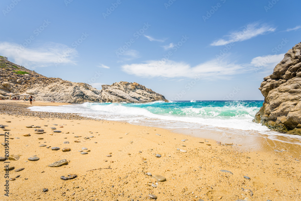 Beautiful sunny cozy holiday bay with big waves with crystal clear blue water sandy beach and a small laguna for sunbathing swimming or surfing, Ikaria Island, Nas Beach, Samos, Sporades, Greece