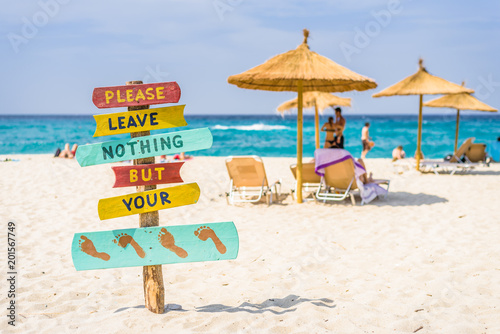 Fototapeta Naklejka Na Ścianę i Meble -  Beautiful sunny coast view to cozy holiday bay with crystal clear blue water sandy beach for sunbathing and heavy huge waves surfing from the greek sea, Ikaria Island, Armenistis, Greece - 08 04 2017