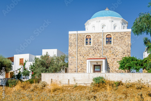 Holy blue white greek church with blue dome agios in traditional community with cross over a blue sky near town Zia, Evangelistra Asfendiou Asomatos, Kos Island, Dodecanese, Greece photo