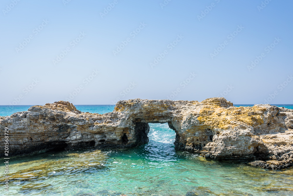 Beautiful sunny coast view to greek beach with rocky arch cove and mediterranean blue sea with crystal clear water and pure white sand empty place, Theologos, Kefalos, Kos, Dodecanese Islands, Greece