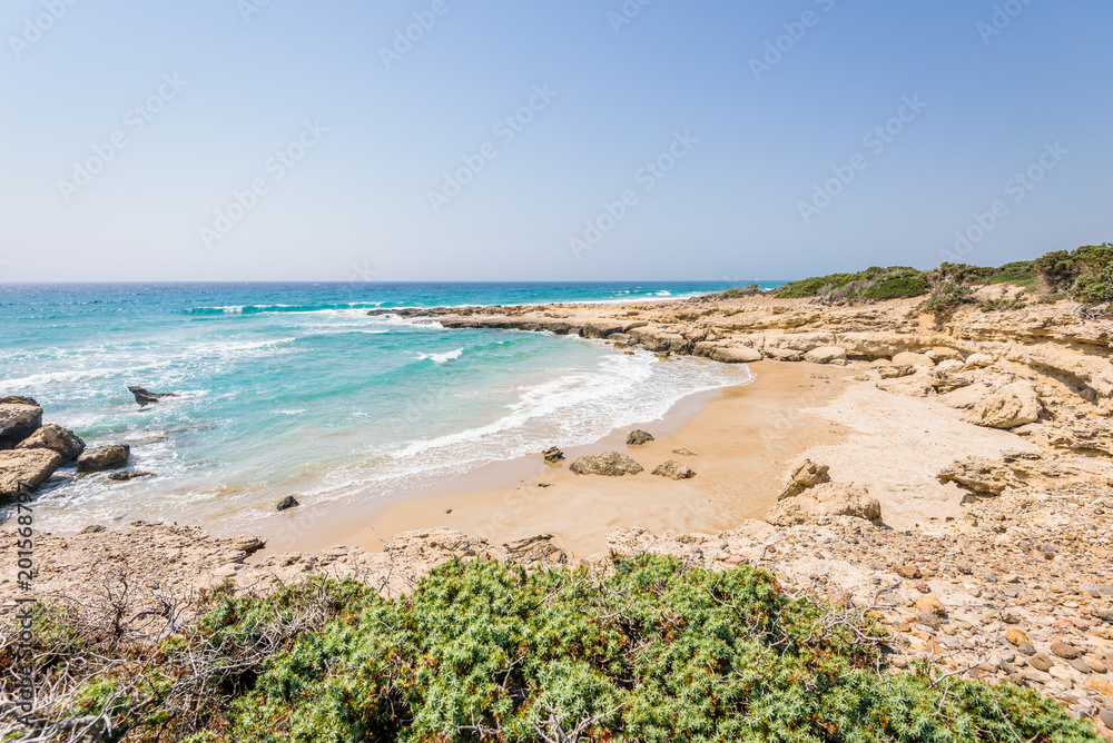 Beautiful sunny coast view to greek beach mediterranean blue sea with crystal clear water and pure white sand empty place with some mountains rocks, Theologos, Kefalos, Kos, Dodecanese Islands, Greece Beautiful sunny coast view to greek beach mediterranean blue sea with crystal clear water and pure white sand empty place with some mountains rocks, Theologos, Kefalos, Kos, Dodecanese Islands, Greece