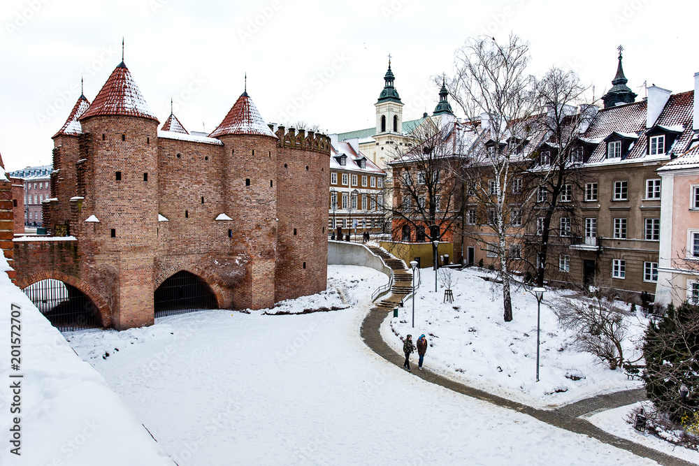 Warsaw Barbacan fortress castle in winter is in the capital city of Poland. Old town is the historic center of Warsaw. Sights of Poland. Snow day.
