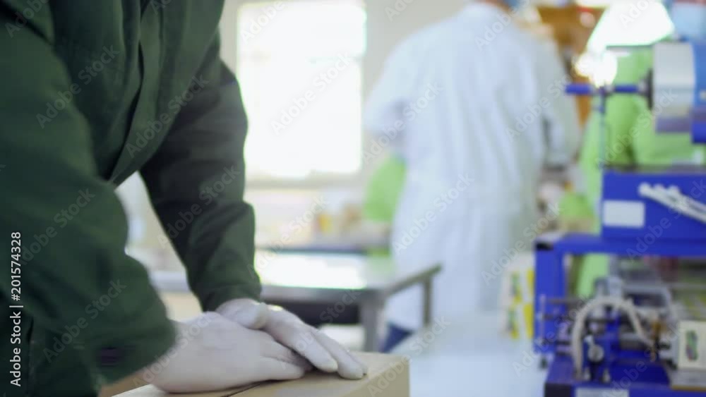 Man packs product into cardboard box Man packs product into cardboard box