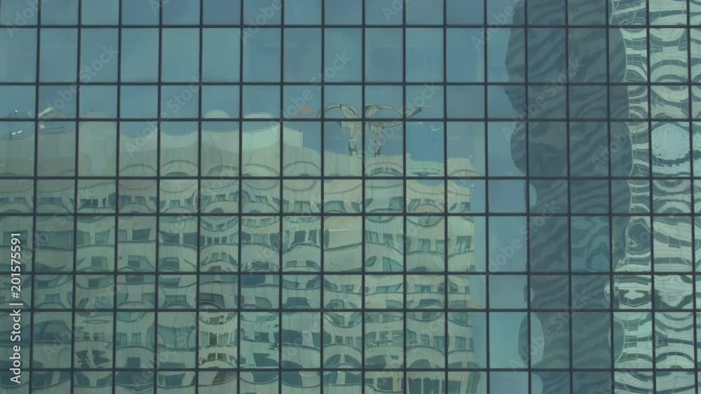 Buildings reflected in the glass facade of a skyscraper Buildings reflected in the glass facade of a skyscraper