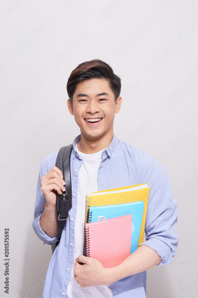 Obraz premium Confident asian handsome student holding books