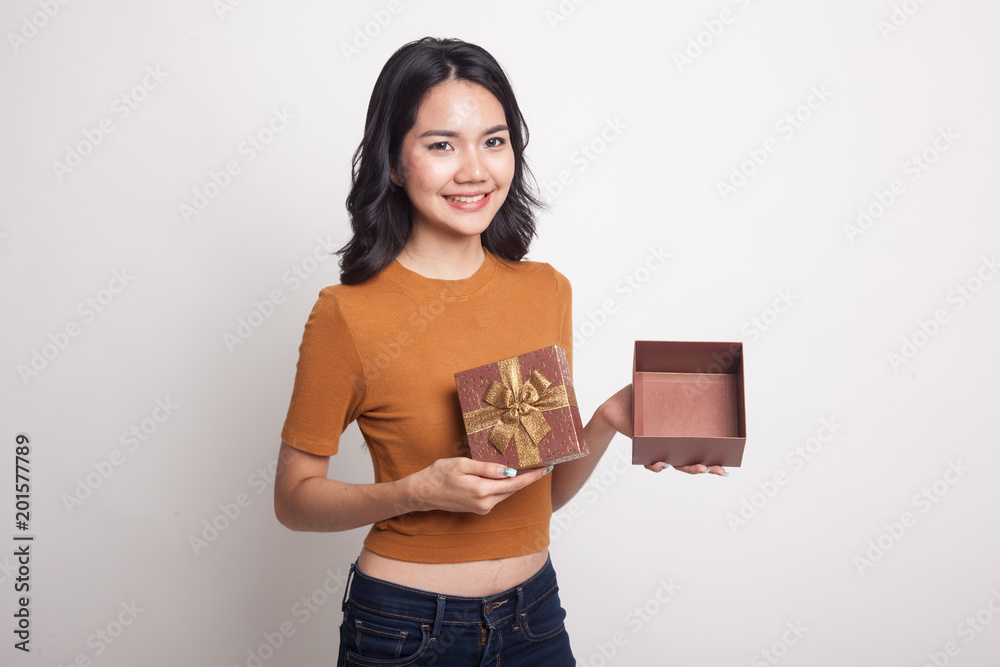 Young Asian woman open a golden gift box. Young Asian woman open a golden gift box.