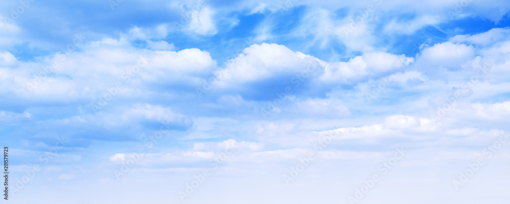 Wide blue sky background, cumulus clouds