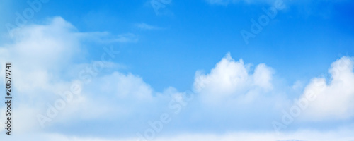 Wide blue sky with white cumulus clouds