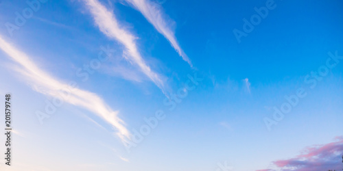 Blue sky with striped cirrus clouds