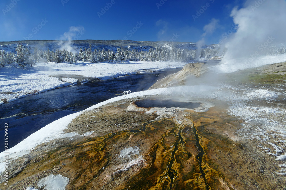 Blue river and colourful volcanic lake, winter in Yellowstone National Park, Wyoming, United States Blue river and colourful volcanic lake, winter in Yellowstone National Park, Wyoming, United States