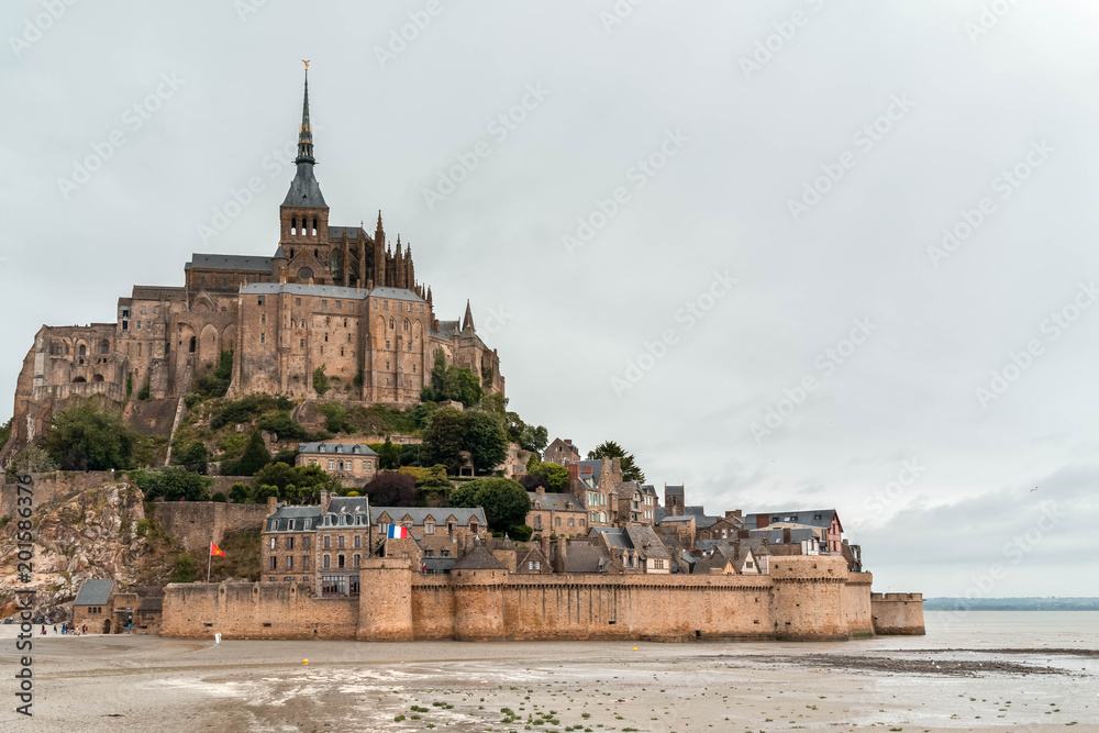 Mont Saint Michel in Normandy under a cloudy sky