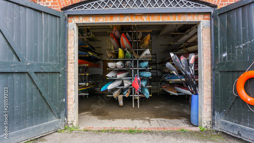 Slika na platnu Colourful canoes in a boatshed in Richmond, London