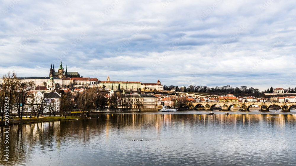 Old Prague is reflected in the waters of the Vltava river