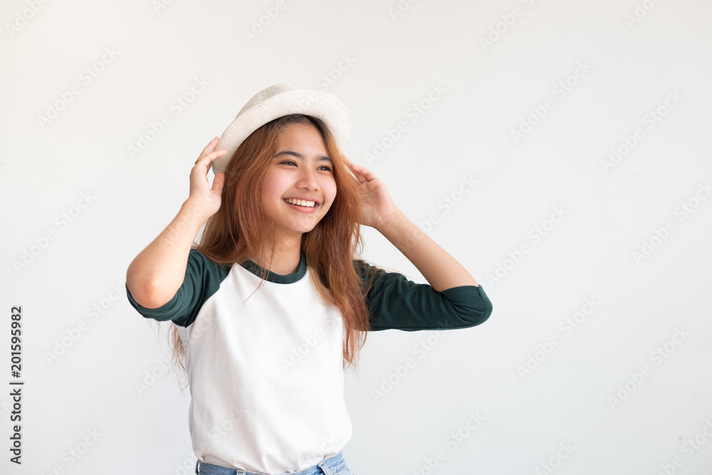 Portrait of asian teenage woman wear hat with smile at white wall,thai ethnic. Portrait of asian teenage woman wear hat with smile at white wall,thai ethnic.