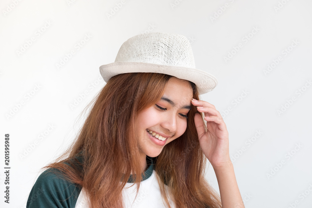 Portrait of asian teenage woman wear hat with smile at white wall,thai ethnic. Portrait of asian teenage woman wear hat with smile at white wall,thai ethnic.