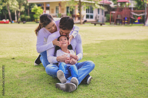 Happy male and female playing with children outside