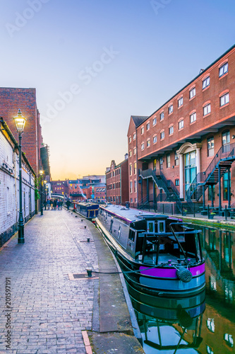 Sunset view of brick buildings alongside a water channel in the central Birmingham, England photo