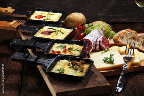 Delicious traditional Swiss melted raclette cheese on diced boiled or baked potato.