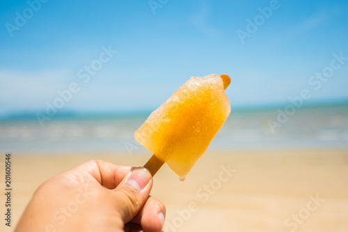 Yellow ice cream stands on the beach in summer.