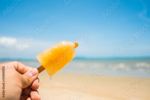 Yellow ice cream stands on the beach in summer.