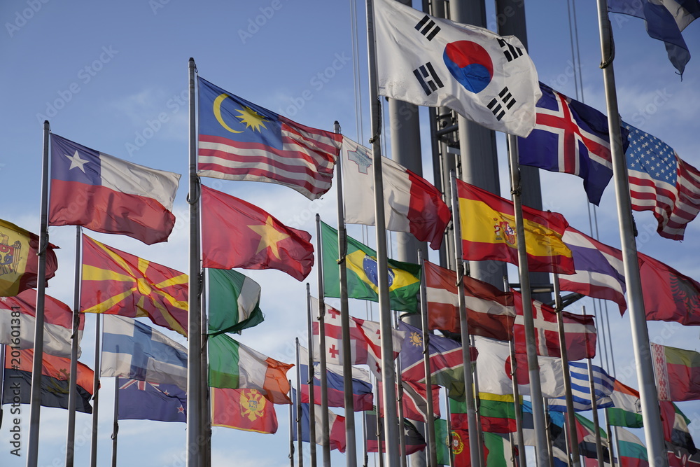 National flags of different countries waving in the wind National flags of different countries waving in the wind