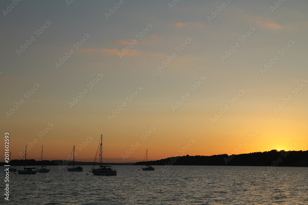 Yachts moored at Shell island sunset scene Yachts moored at Shell island sunset scene