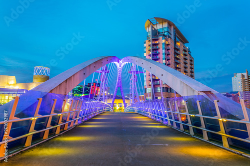 View of an illuminated footbridge in Salford quays during night in Manchester, England