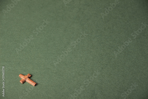 Christian cross on green background with space for writing