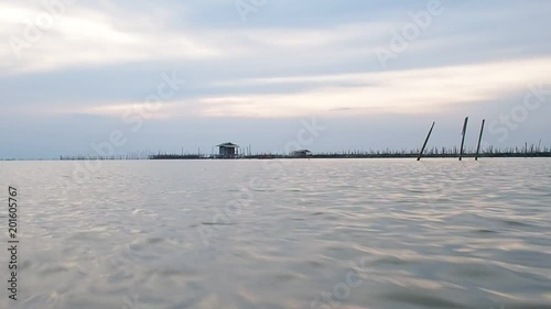 Fisheries areas villager has fish and shirm farm floating basket for keeping live fish in water at Kohyo in Songkla, Thailand (South of Thailand). This area is famous in Estuarine fisheries.