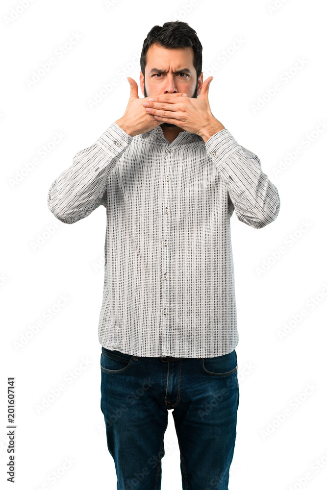 Handsome man with beard covering mouth with hands Handsome man with beard covering mouth with hands