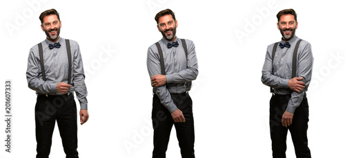 Middle age man, with beard and bow tie confident and happy with a big natural smile laughing