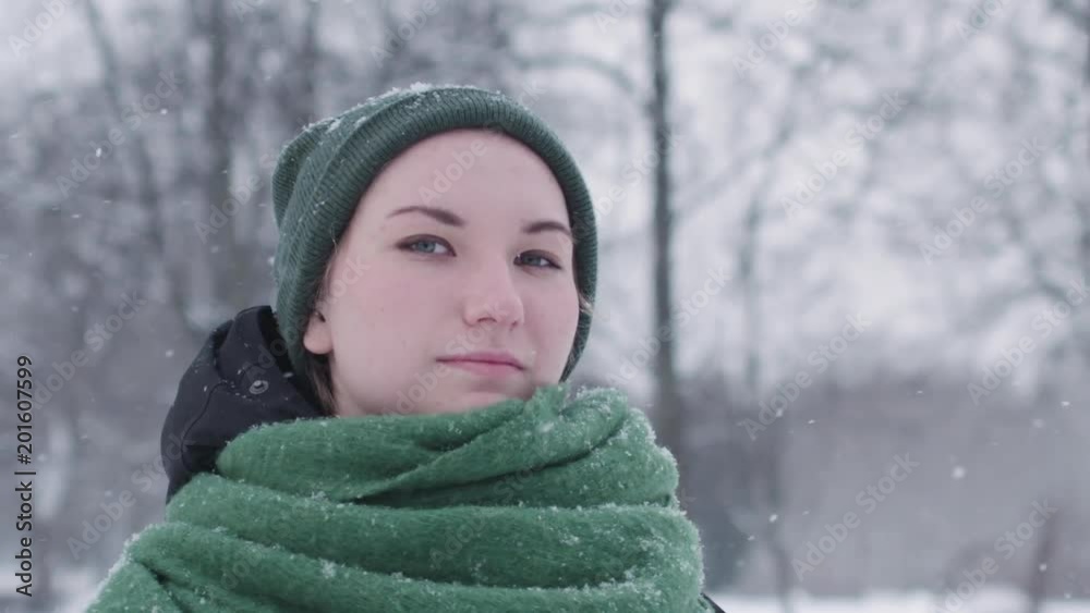 Slow motion portrait of teen girl standing in park on a sunny winter day Slow motion portrait of teen girl standing in park on a sunny winter day