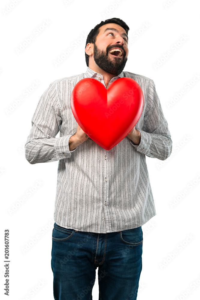 Handsome man with beard holding a heart toy Handsome man with beard holding a heart toy
