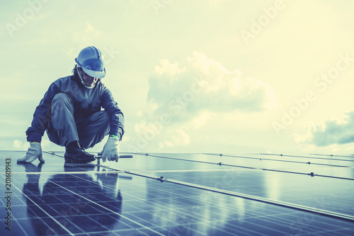 engineers repairing solar panel at generating power of solar power plant   technician in industry uniform on level of job description at industrial