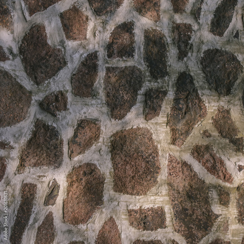 Texture of a wall from various stone blocks creating a pattern, background.