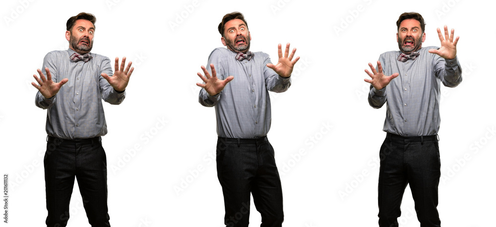 Middle age man, with beard and bow tie disgusted and angry, keeping hands in stop gesture, as a defense, shouting Middle age man, with beard and bow tie disgusted and angry, keeping hands in stop gesture, as a defense, shouting