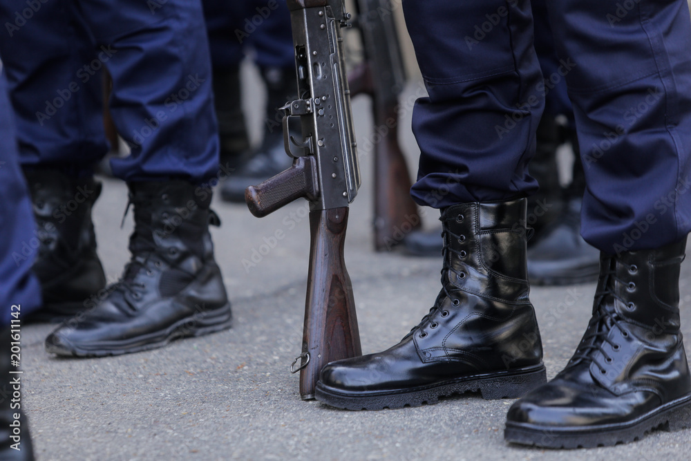 Soldiers with their bayonet guns wait for instructions