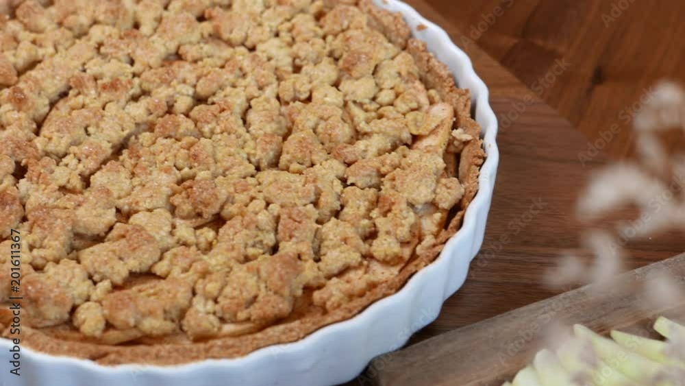Apple crisp or Apple crumble pie a dessert baked chopped apples topped with a crisp streusel crust. set on wooden table. Apple crisp or Apple crumble pie a dessert baked chopped apples topped with a crisp streusel crust. set on wooden table.