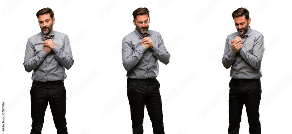 Middle age man, with beard and bow tie crying depressed full of sadness expressing sad emotion Middle age man, with beard and bow tie crying depressed full of sadness expressing sad emotion