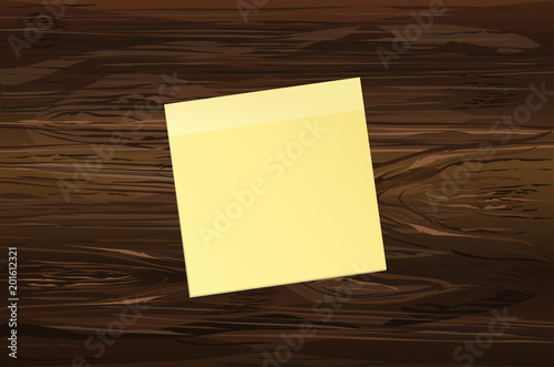 Yellow sheet of paper for notes. Sticker on wooden background. 