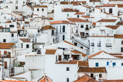 View of an old spanish town Comares, Andalusia. White facades and reddish-brown roofs 