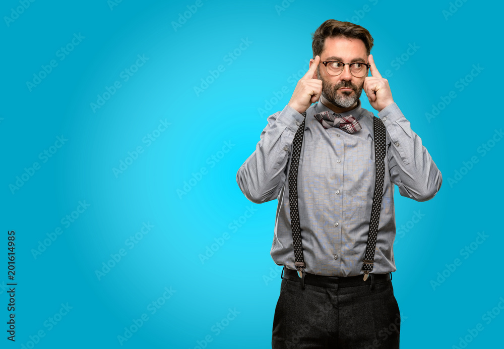 Middle age man, with beard and bow tie doubt expression, confuse and wonder concept, uncertain future Middle age man, with beard and bow tie doubt expression, confuse and wonder concept, uncertain future