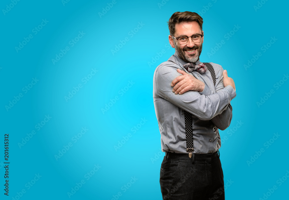 Middle age man, with beard and bow tie confident and happy with a big natural smile laughing, natural expression
