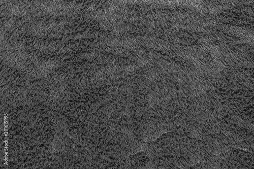 Black background texture of black fleece. Plush velour closeup